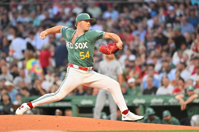 MLB Texas Rangers at Boston Red Sox Baseball pitcher in a green Boston Red Sox uniform delivering a pitch on the mound with a crowded stadium in the background.